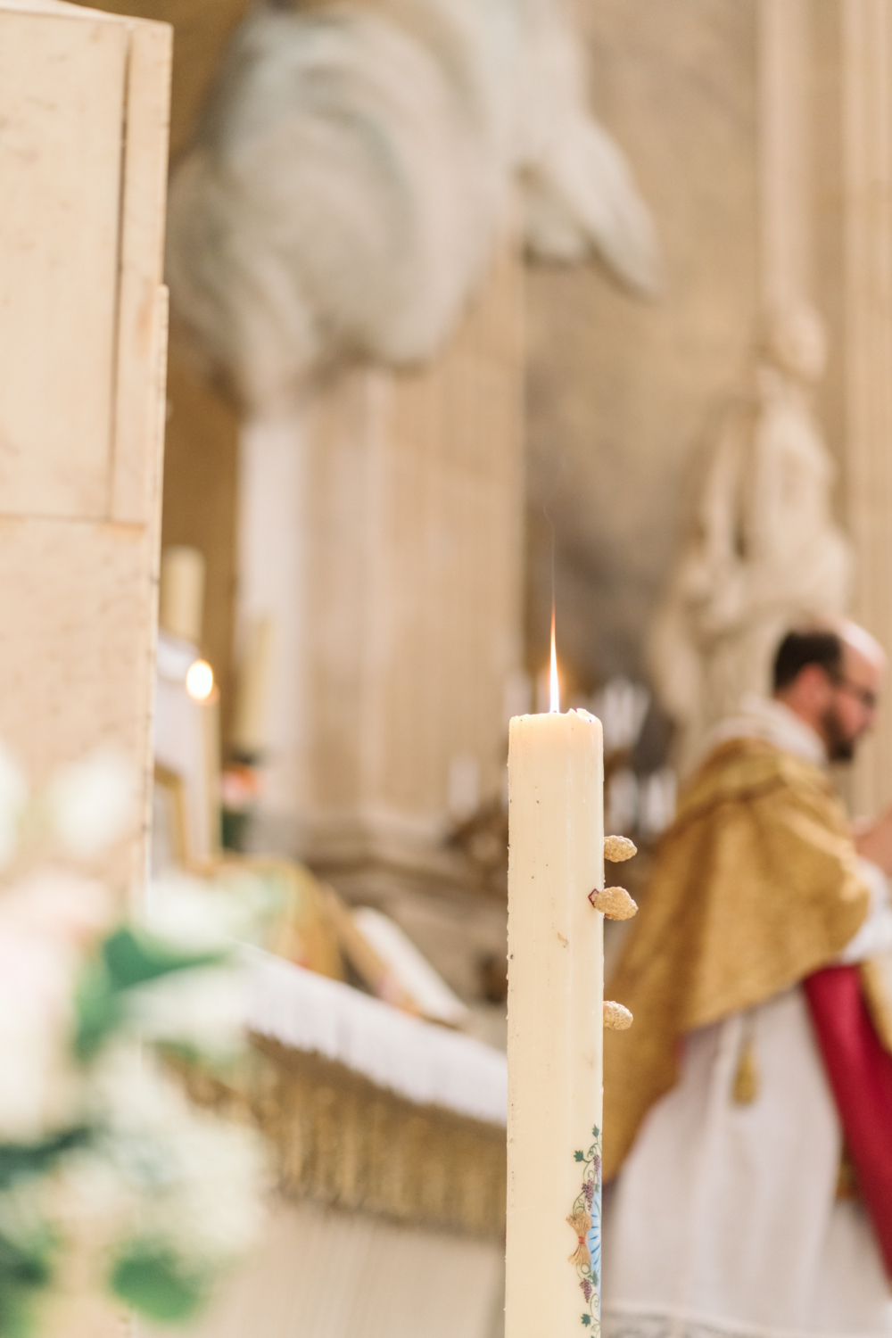 priest and candle at church in paris