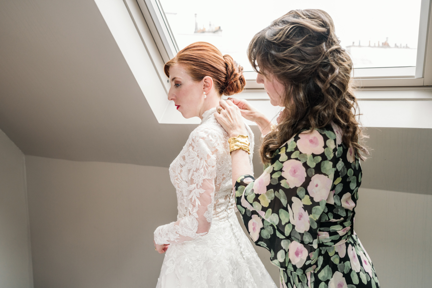mother buttons bride's gown in paris