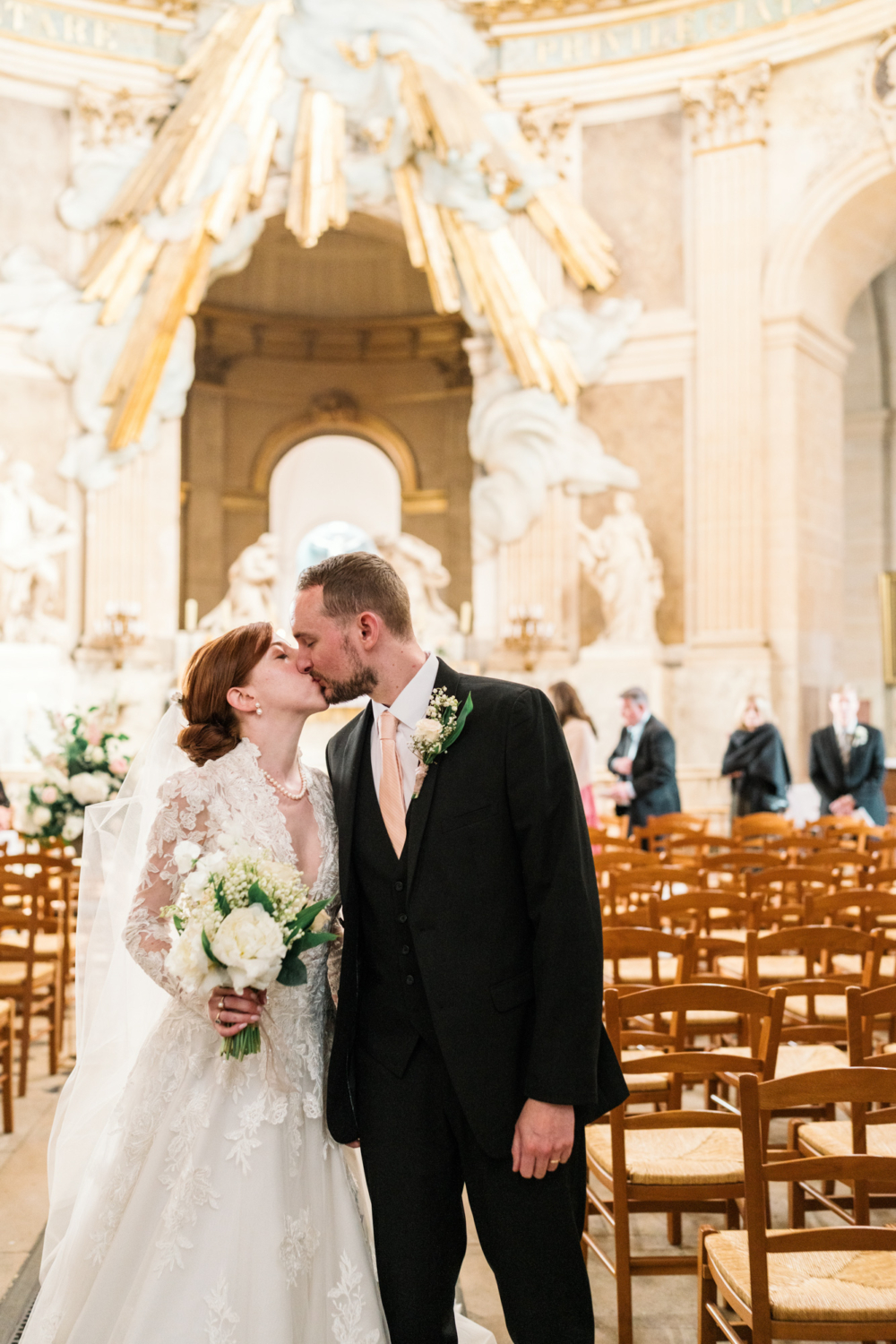 bride and groom kiss after their ceremony in paris