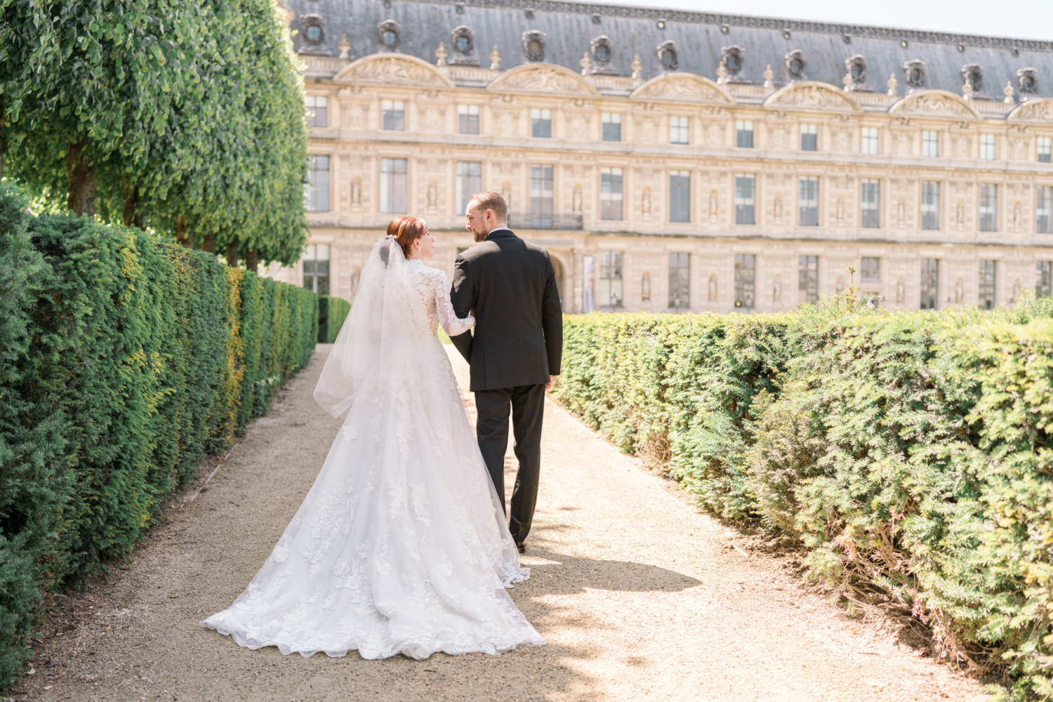 bride and from walk arm in arm after their wedding in paris