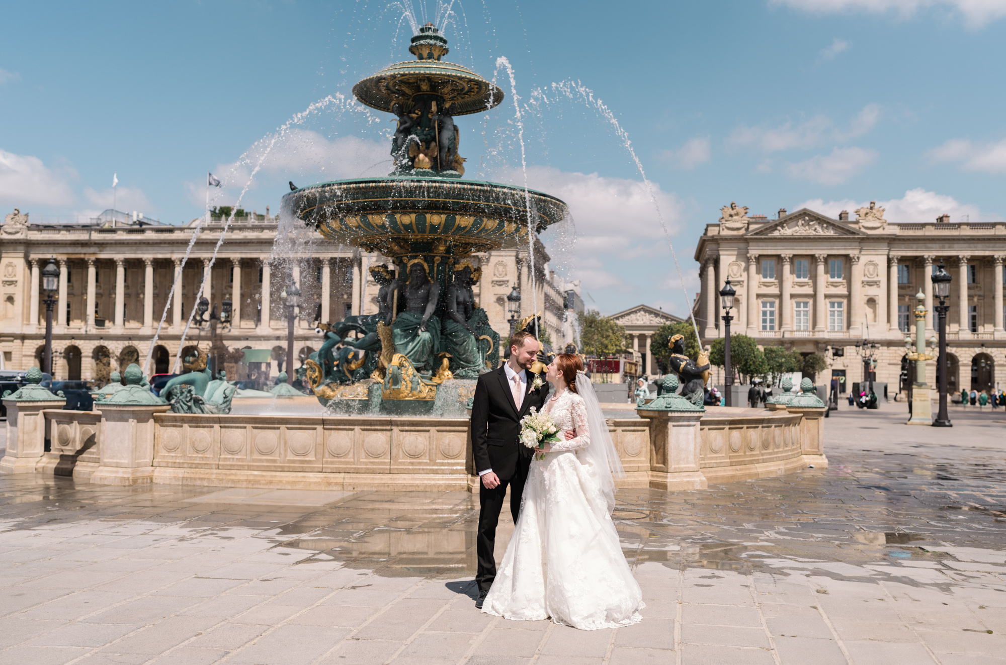 bride and groom pose after their wedding in paris at place de la concorde