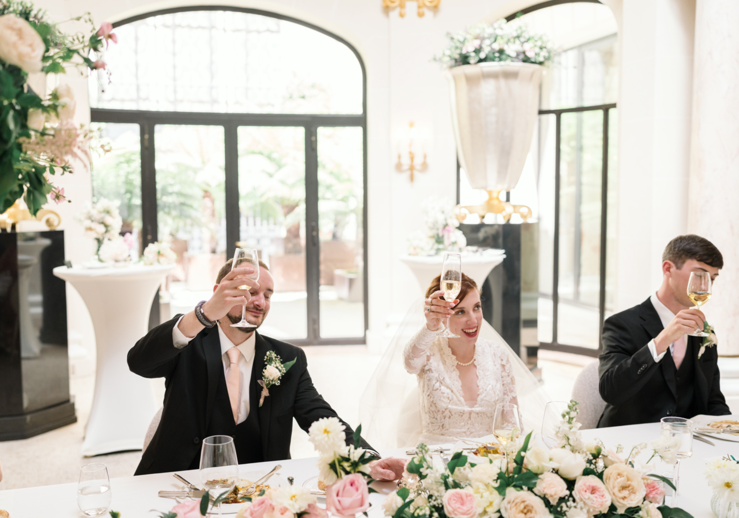 bride and groom toast at the peninsula hotel paris