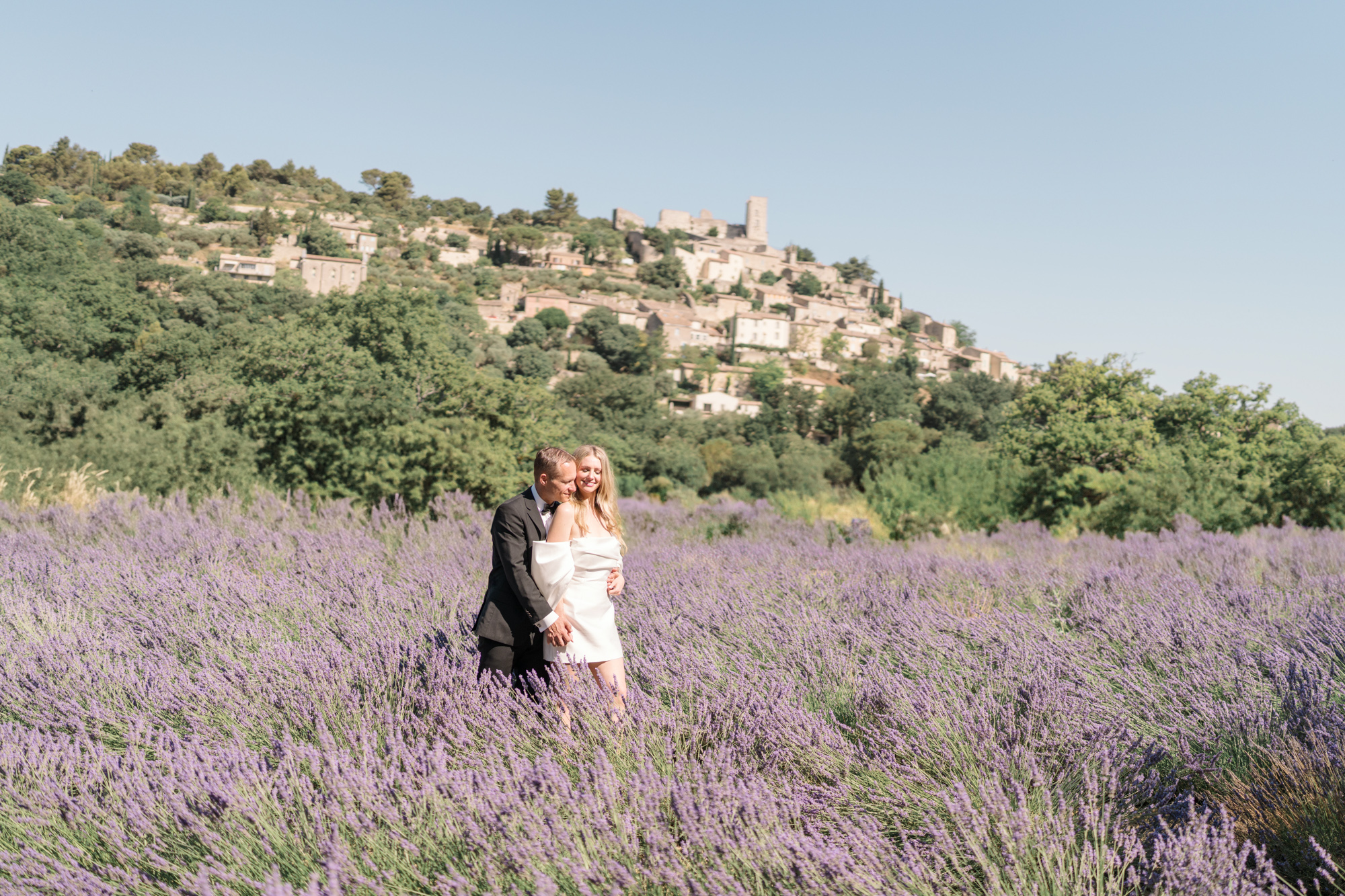 bride and groom embrace in a lavender field in gordes france