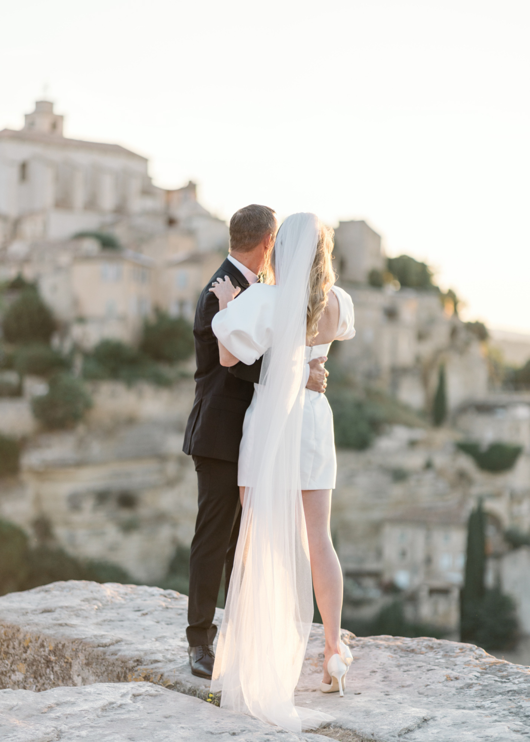 bride and groom embrace on their wedding day in gordes france