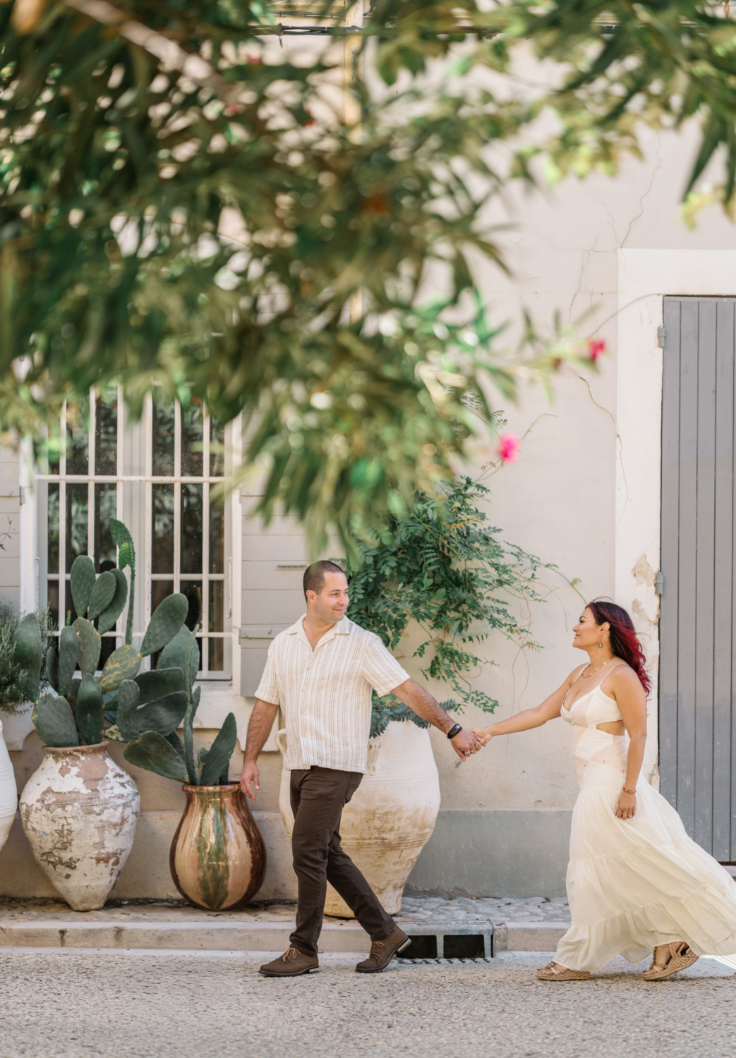 couple walk in front of cactus in arles france