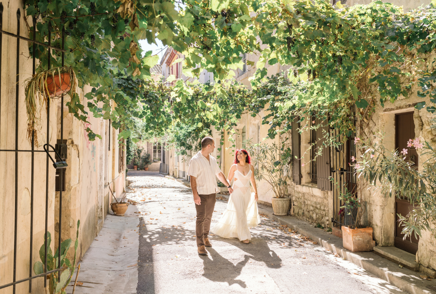 couple laugh and walk in arles france
