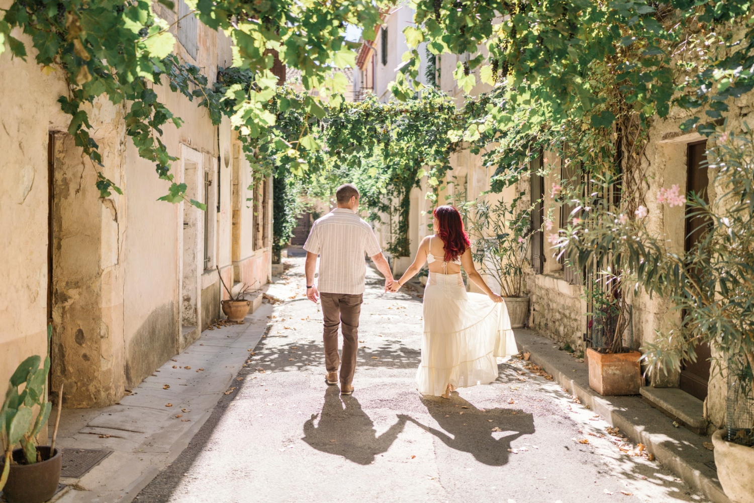 couple walk hand in hand in arles france
