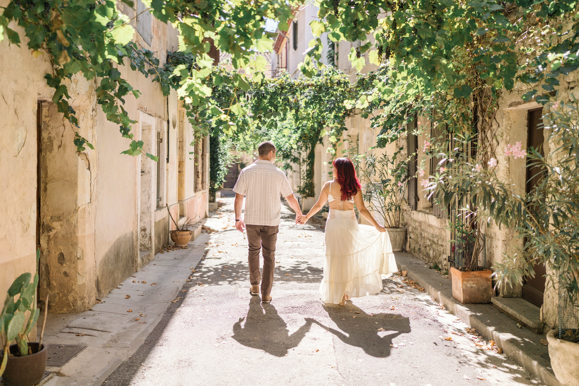 couple walk hand in hand in arles france