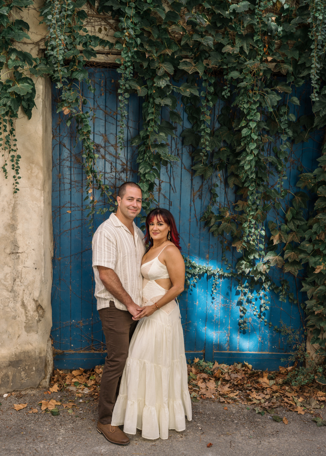 couple pose in front of blue door on their anniversary in arles france