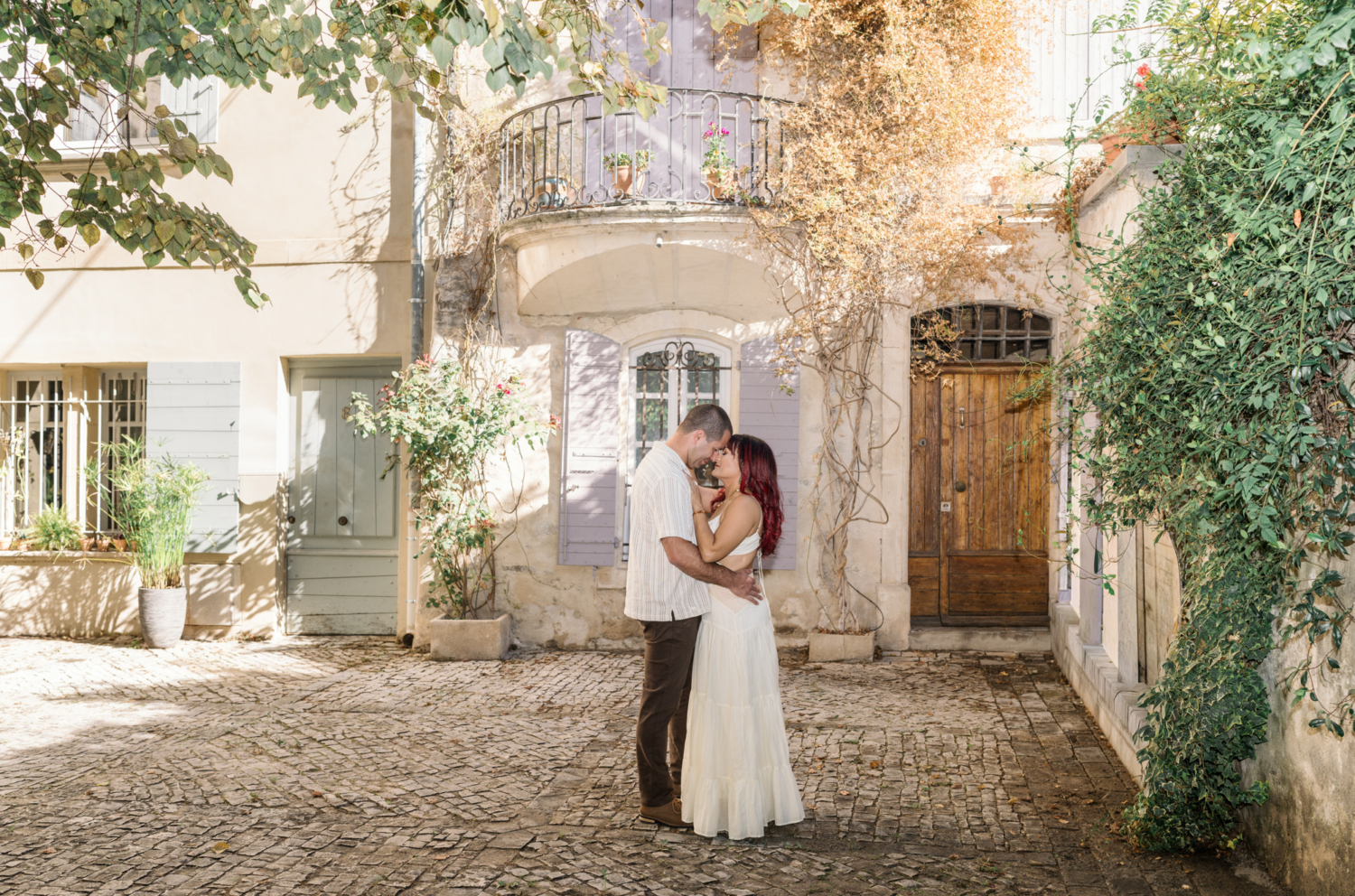 husband and wife embrace in courtyard in arles france