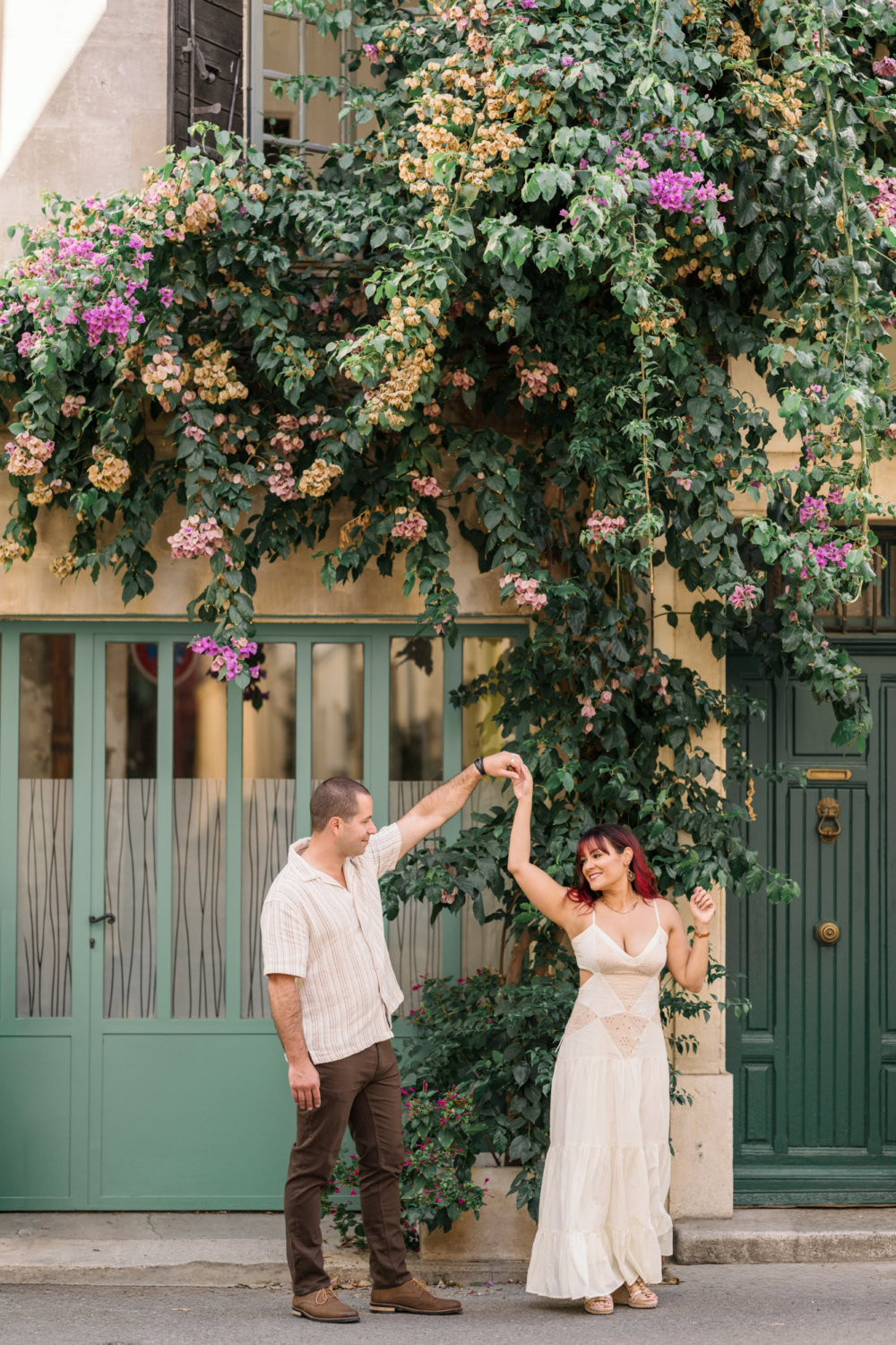 married couple dance in front of green door in arles france