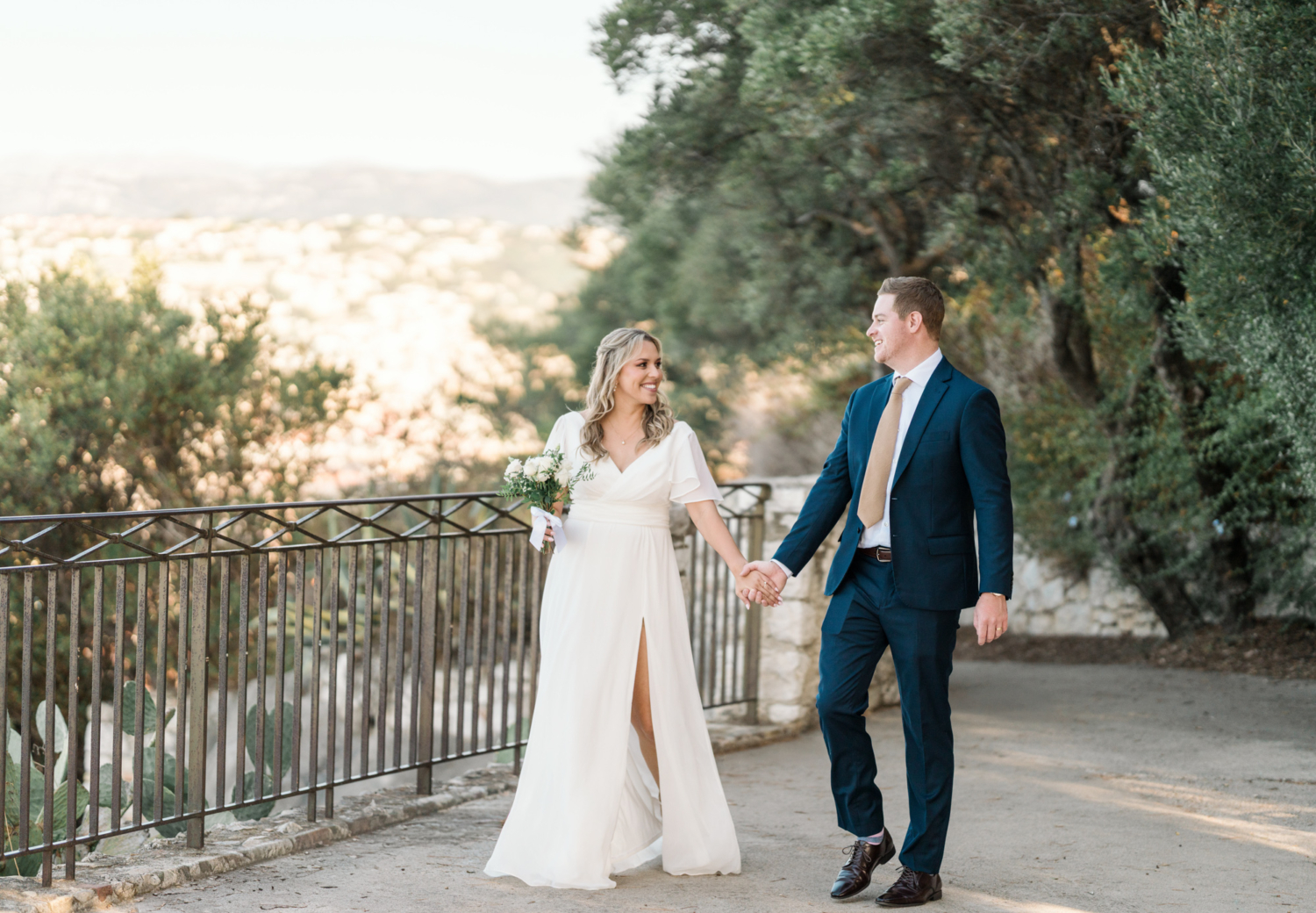 bride and groom walk in the park after their wedding in nice france