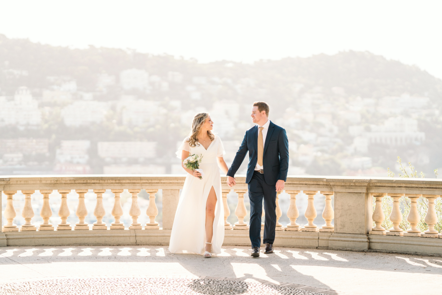bride and groom walk in nice france at castle hill