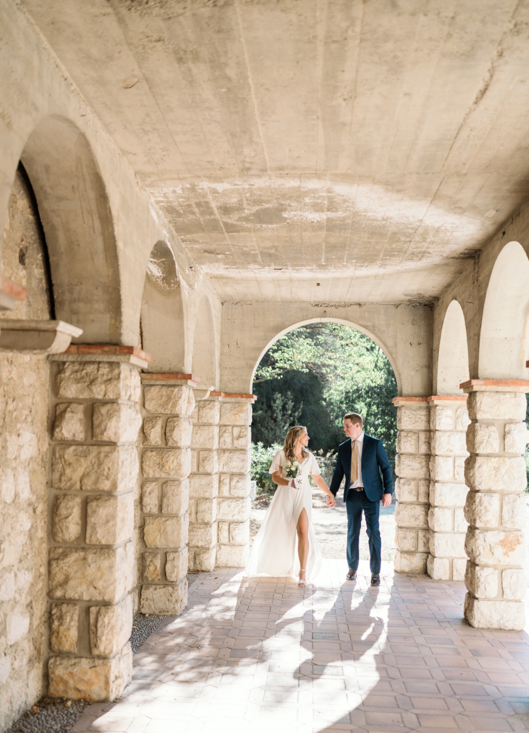 bride and groom walk on castle hill nice france