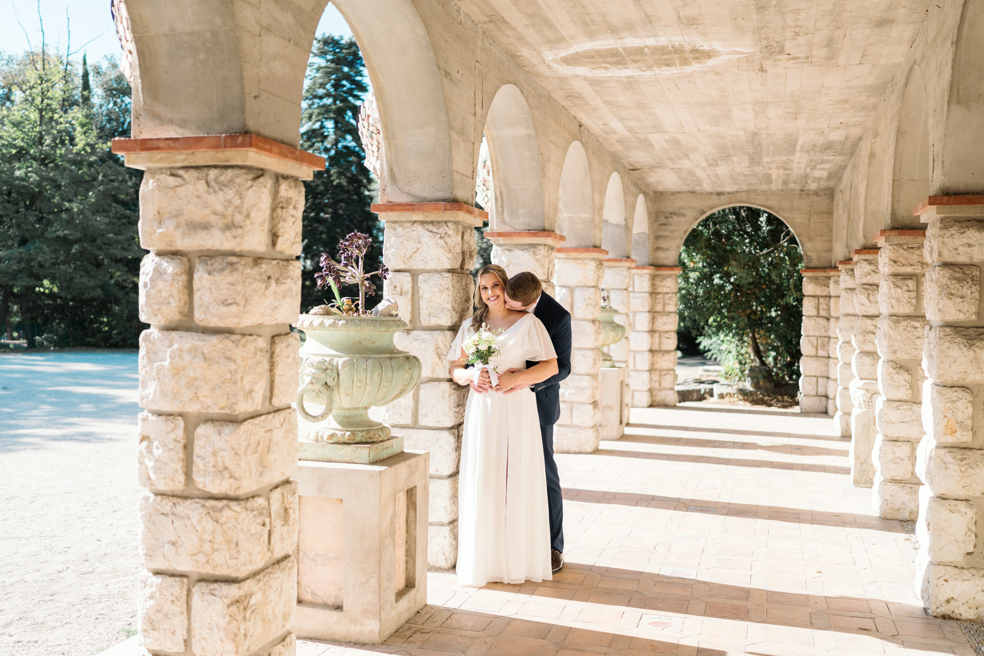 bride and groom pose on castle hill nice france