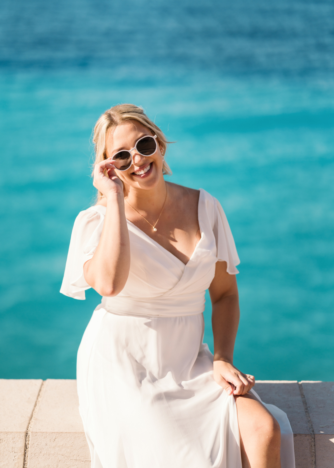 bride poses in sunglasses in nice france
