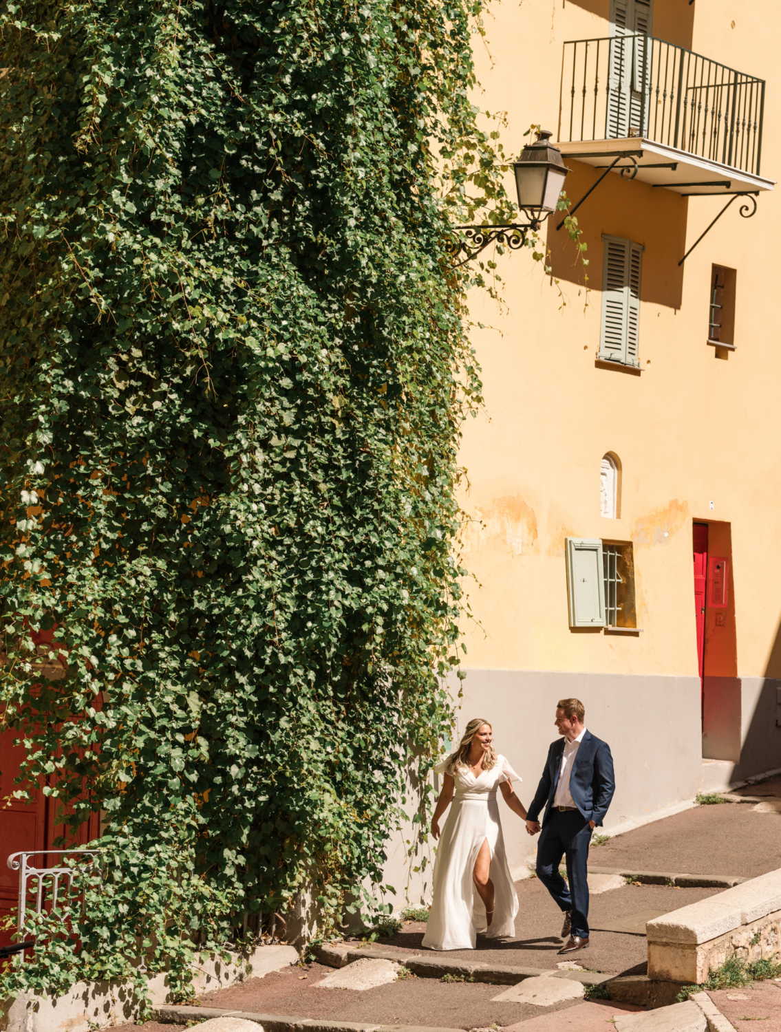 bride and groom walk after their wedding in old town nice france