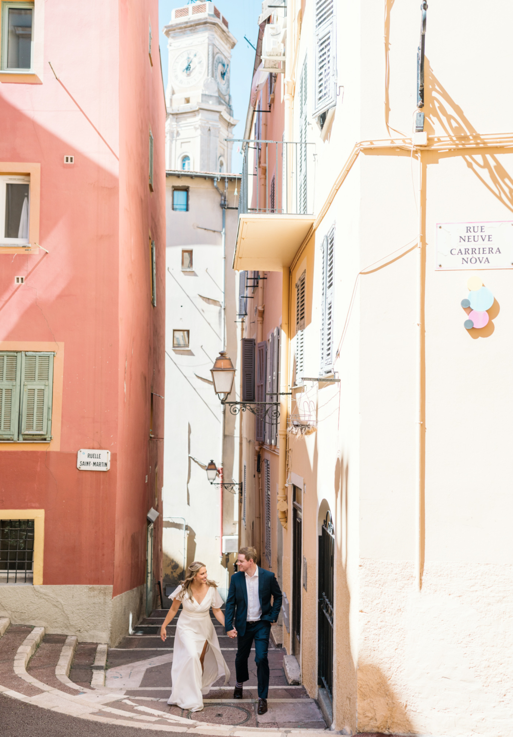 bride and groom walk in old town nice france on their wedding day