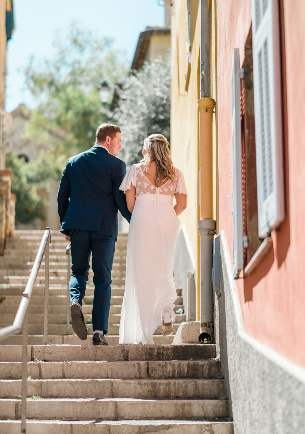 bride and groom walk in old town nice france