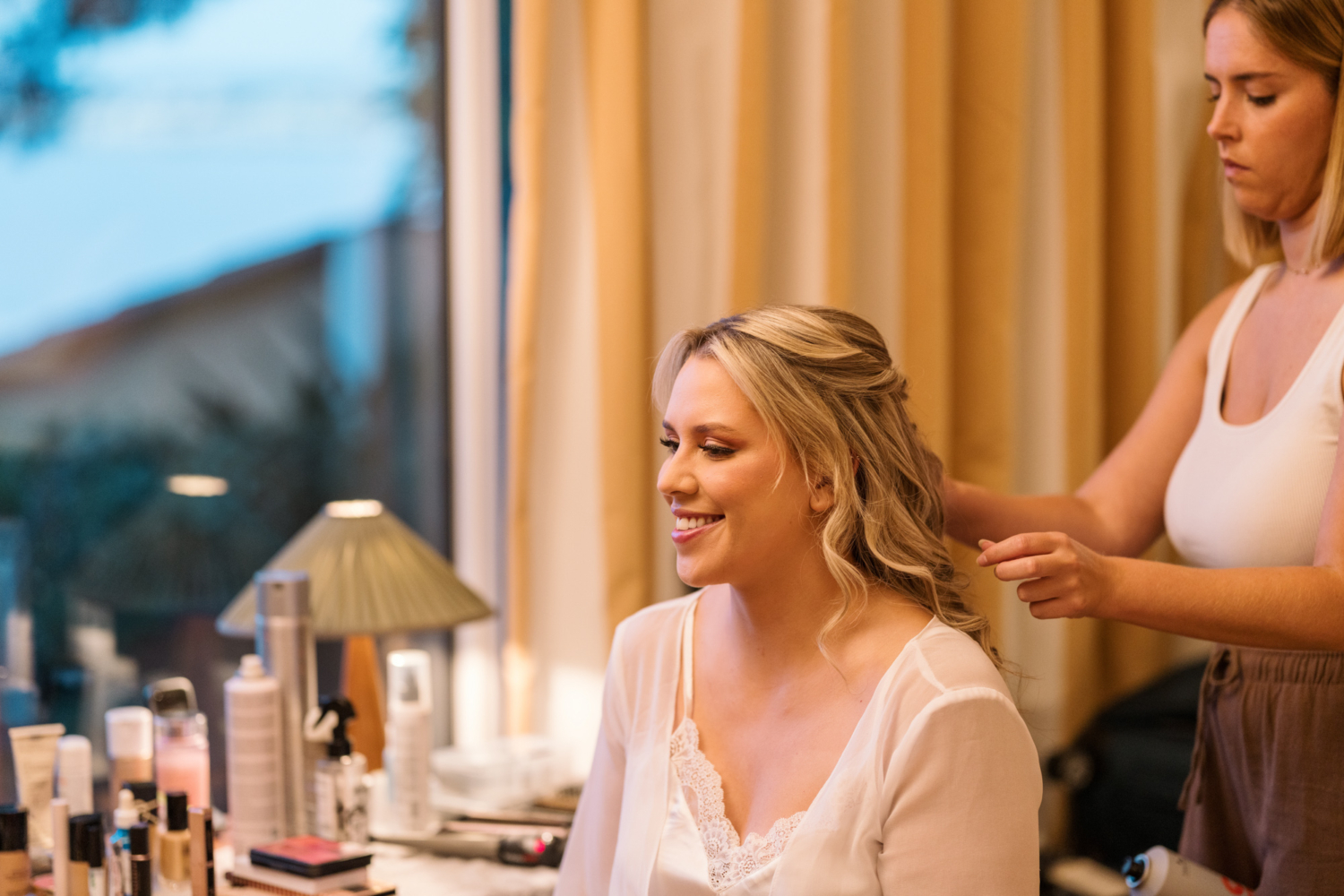bride gets her makeup done on her wedding day in nice france