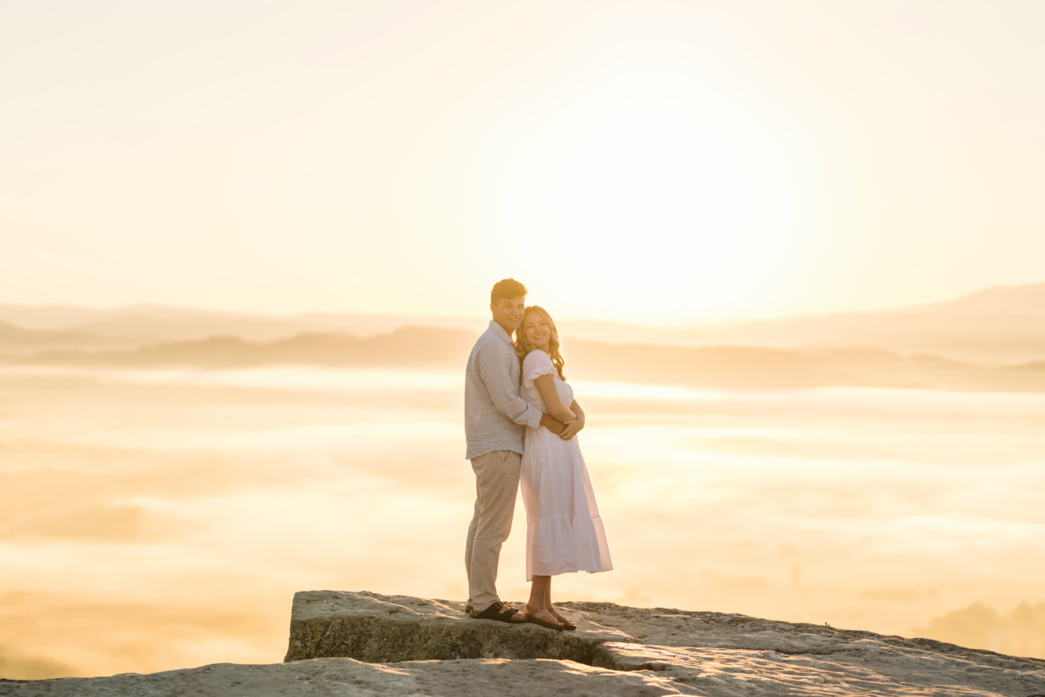 engaged couple embrace at sunrise in gordes, provence france