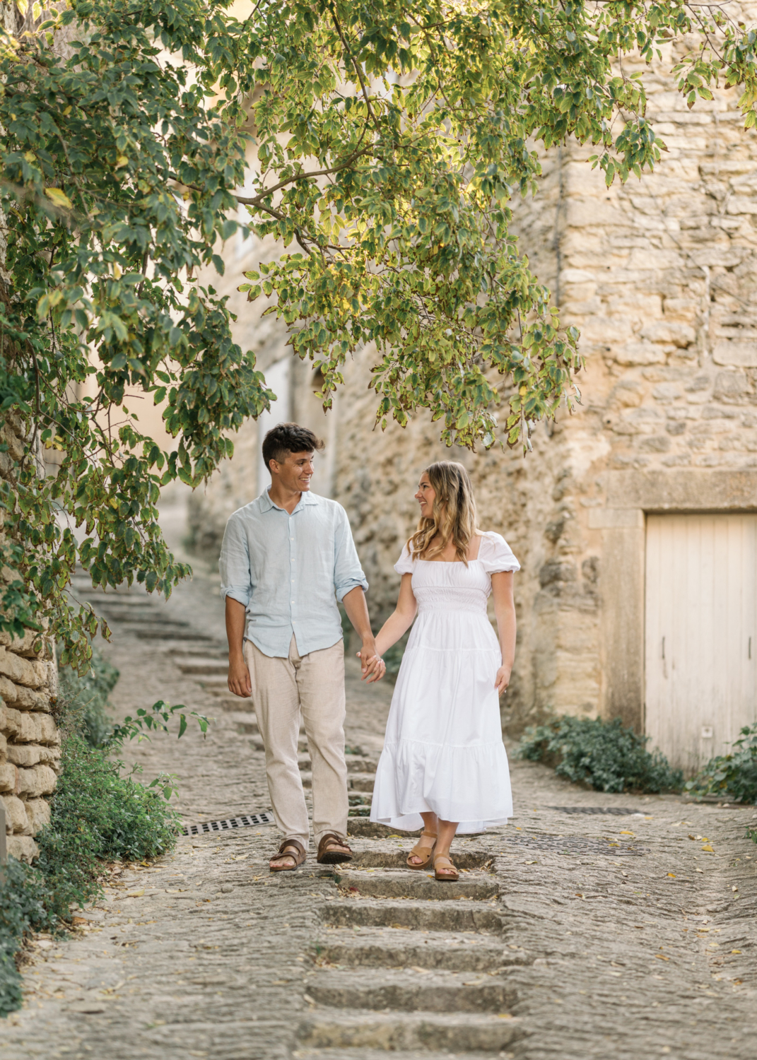 engaged couple walk in gordes, provence france
