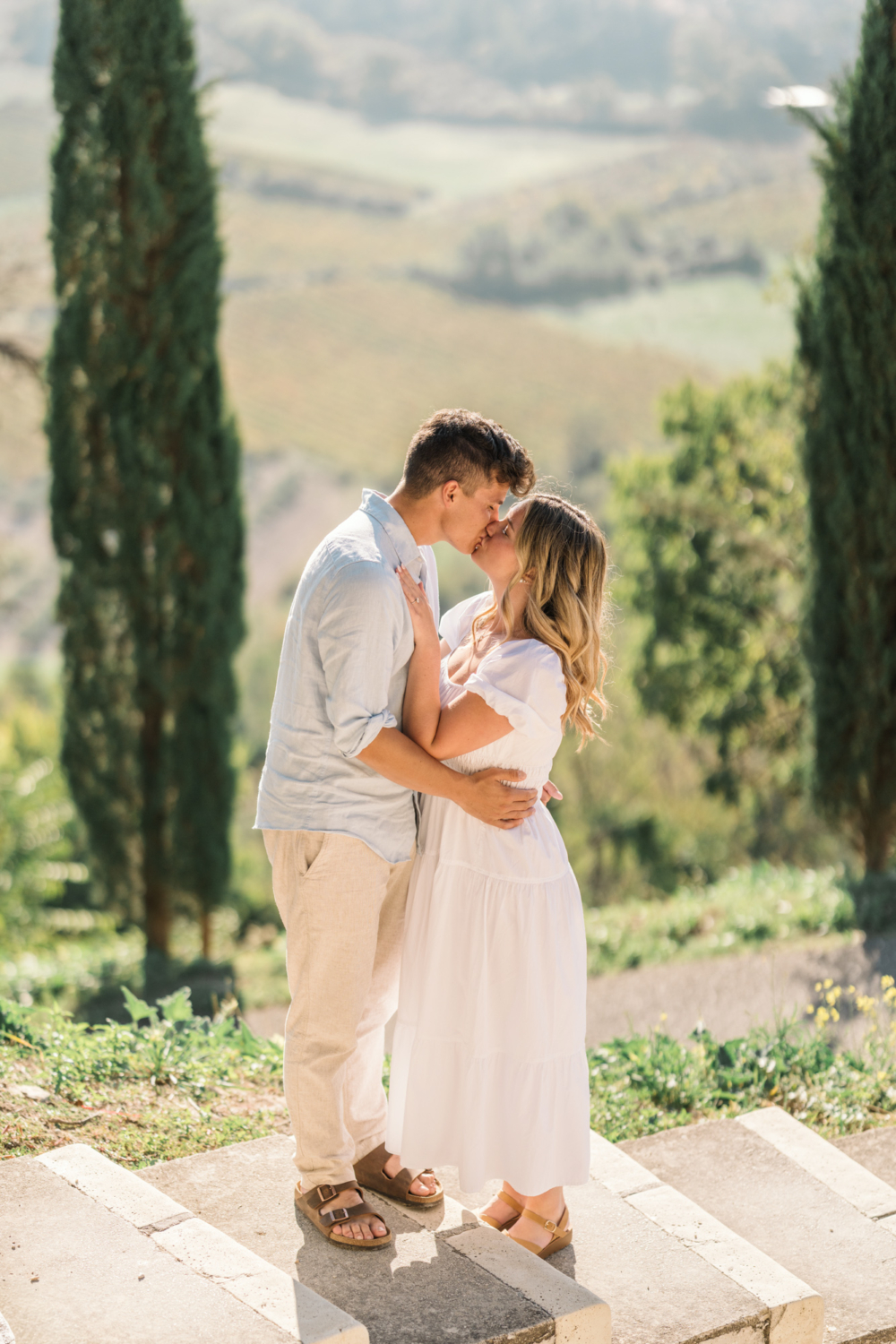 engaged couple kiss in gordes, provence france