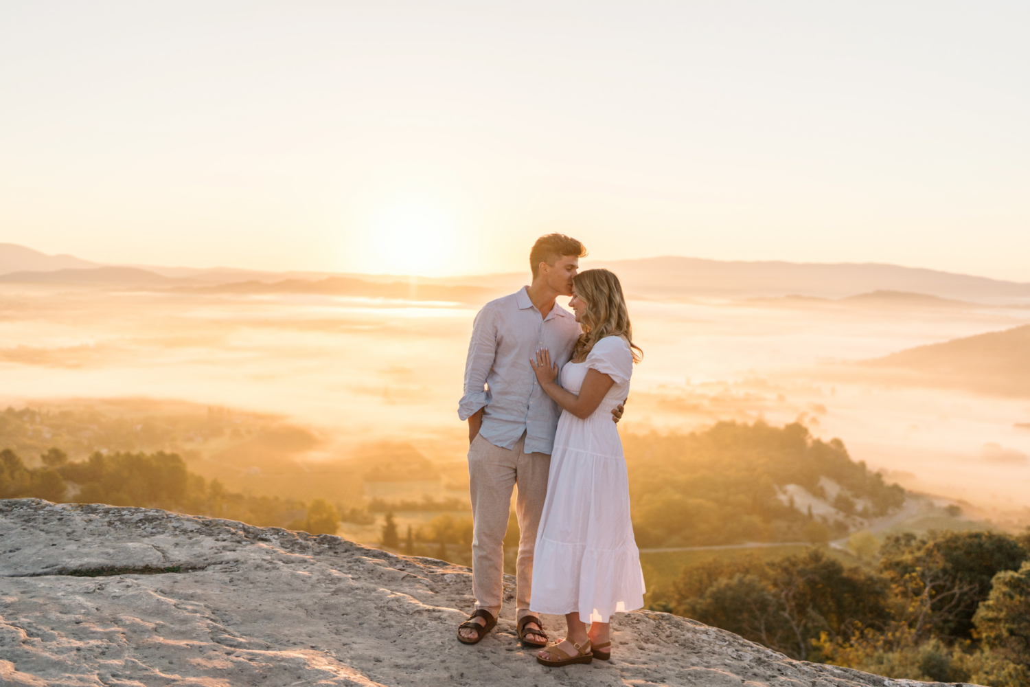engaged couple embrace at sunrise in gordes, provence france