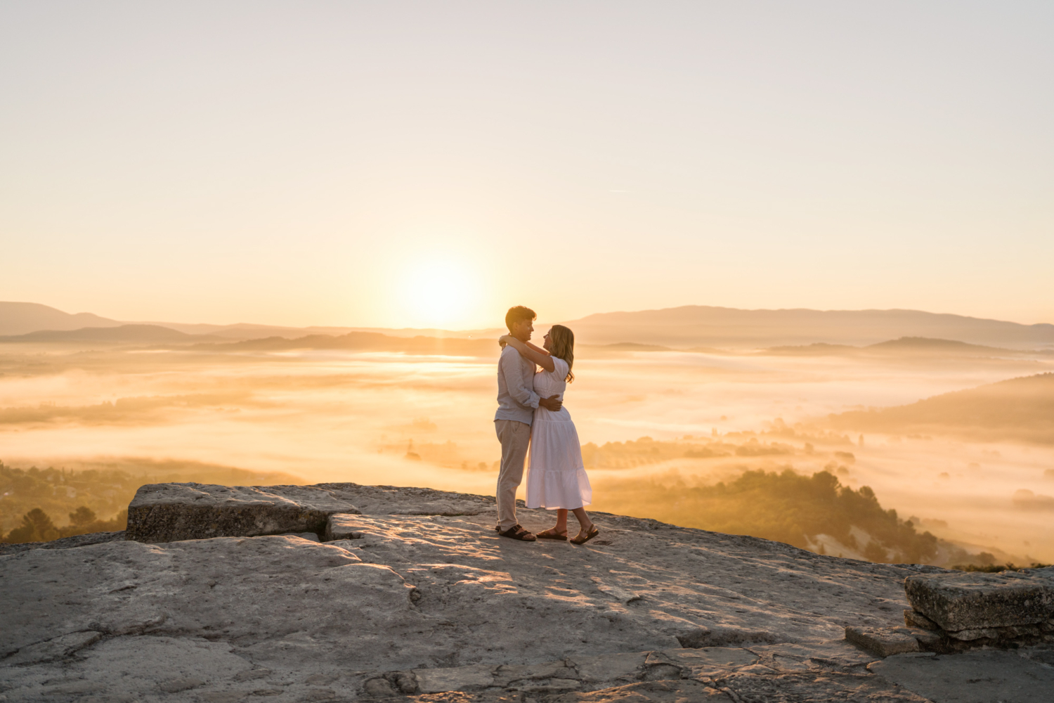 engaged couple embrace at sunrise in gordes, provence france