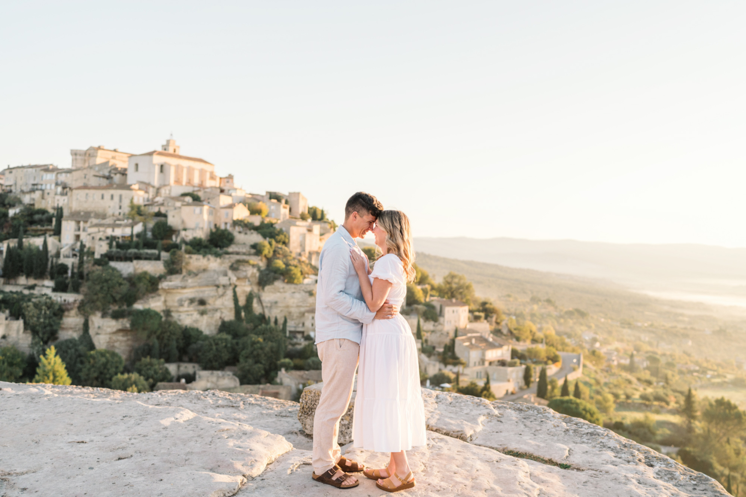engaged couple embrace in gordes, provence france