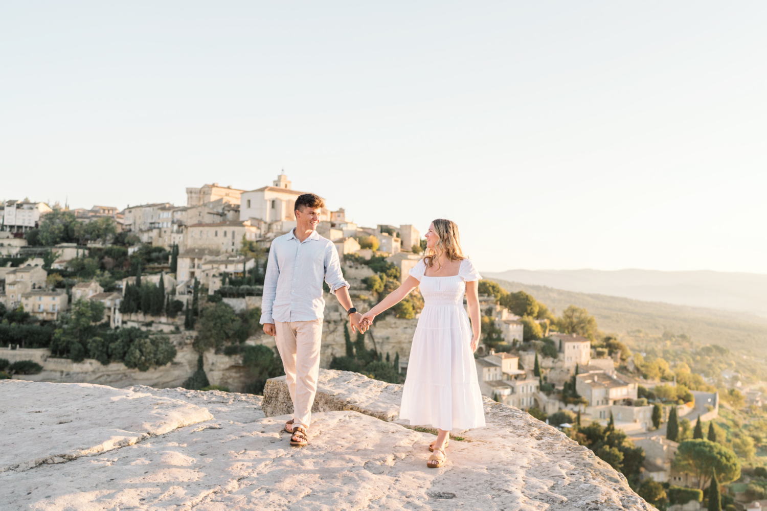 engaged couple walk in gordes, provence france