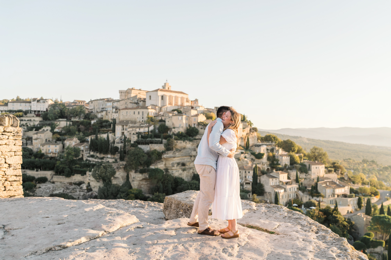 engaged couple hug in gordes, provence france
