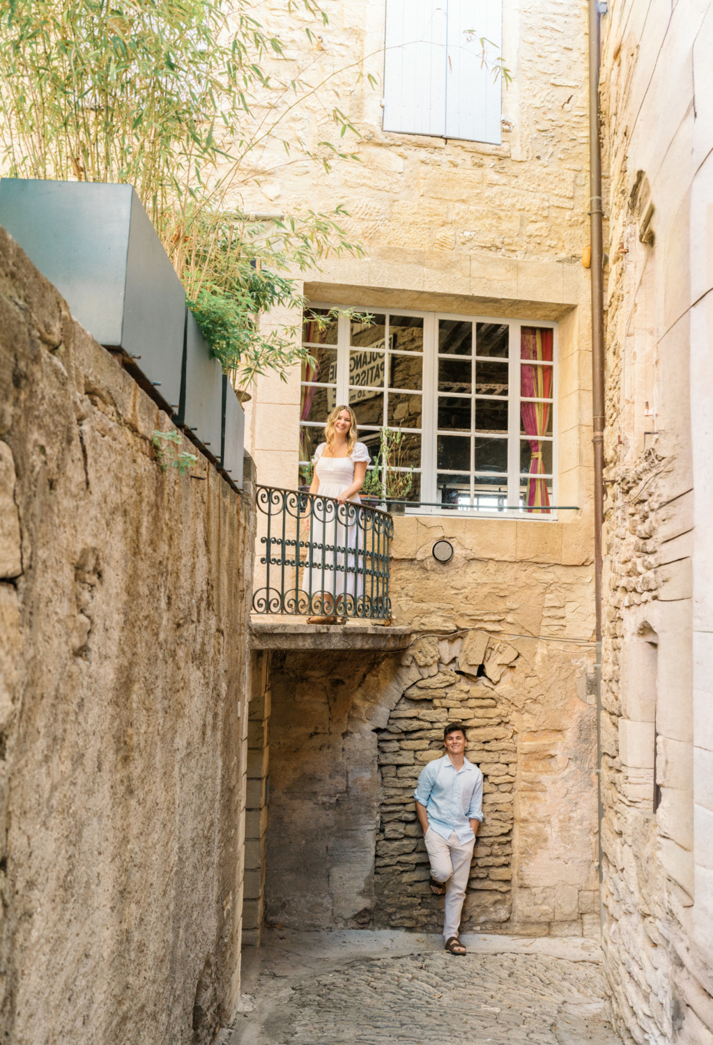 engaged couple pose in gordes, provence france