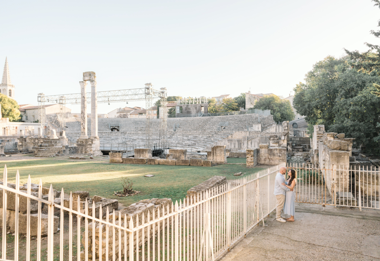 engaged couple embracing outside roman theater in arles france