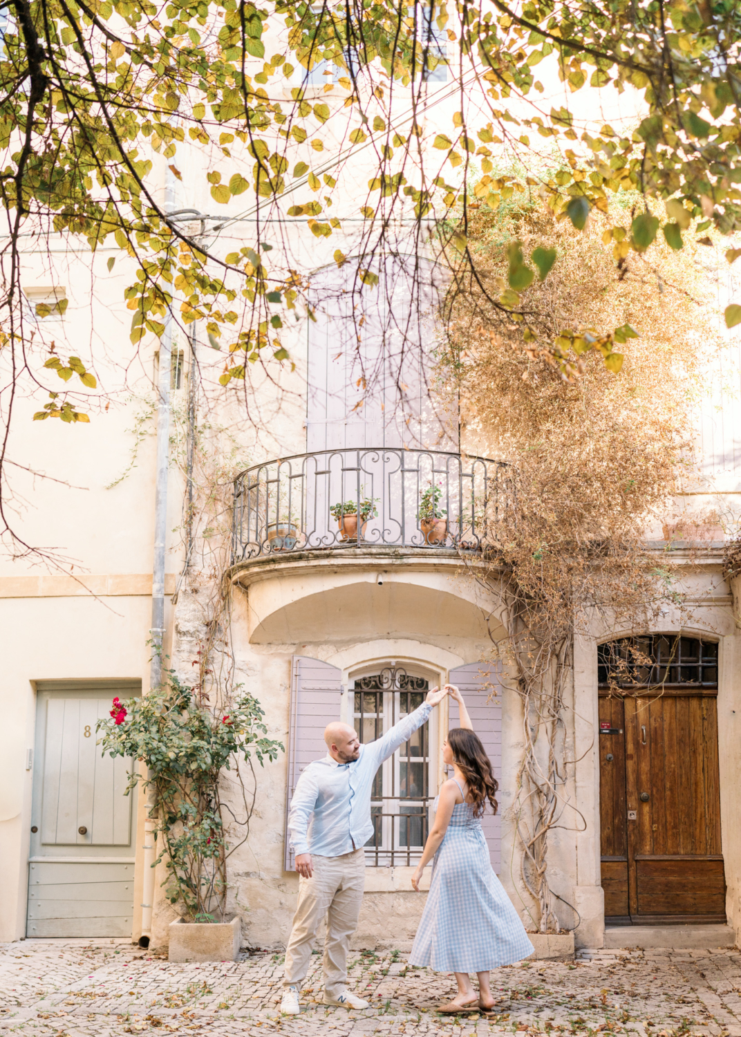 engaged couple dance in charming neighborhood in arles france