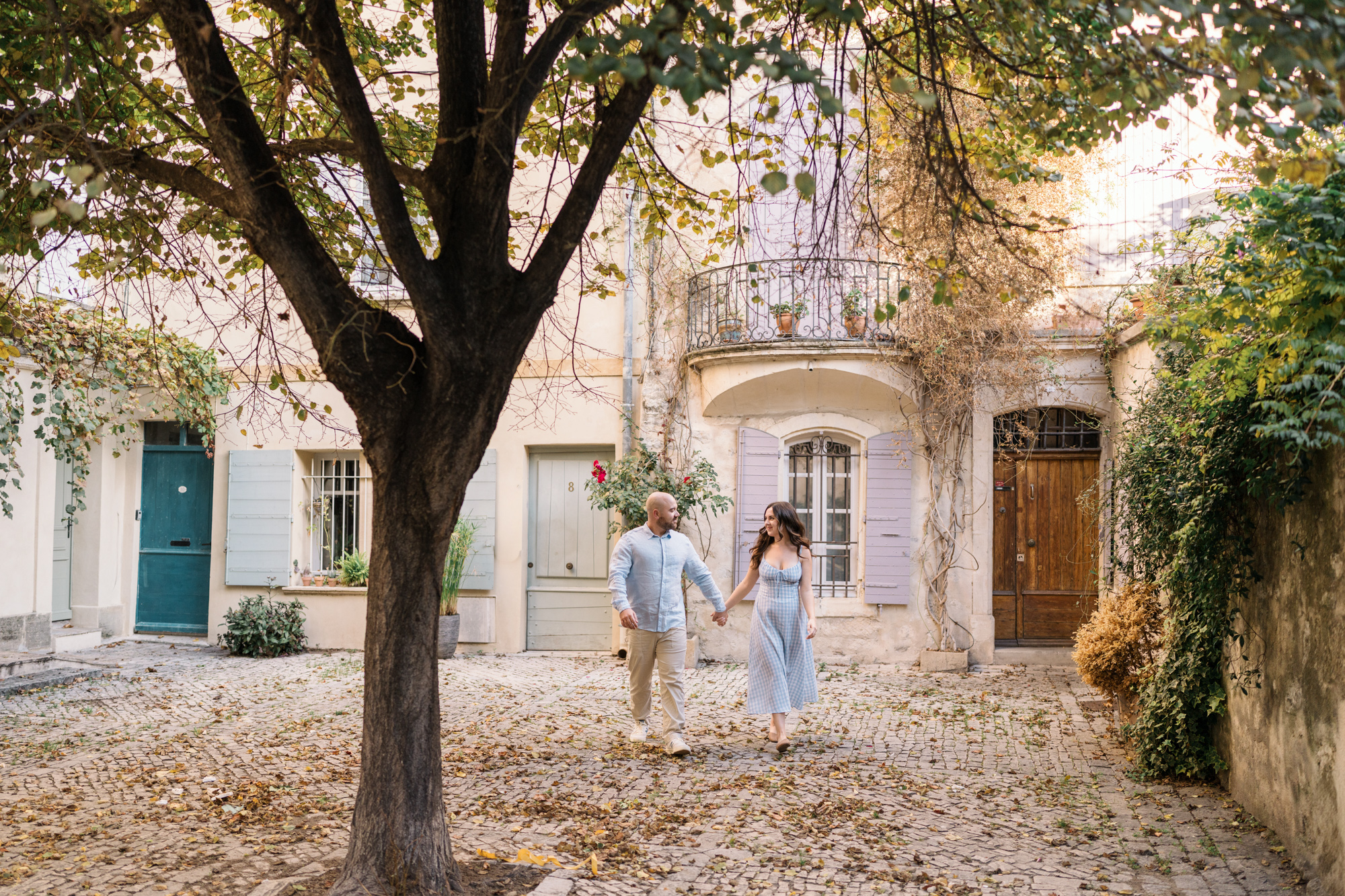 engaged couple walk in arles france
