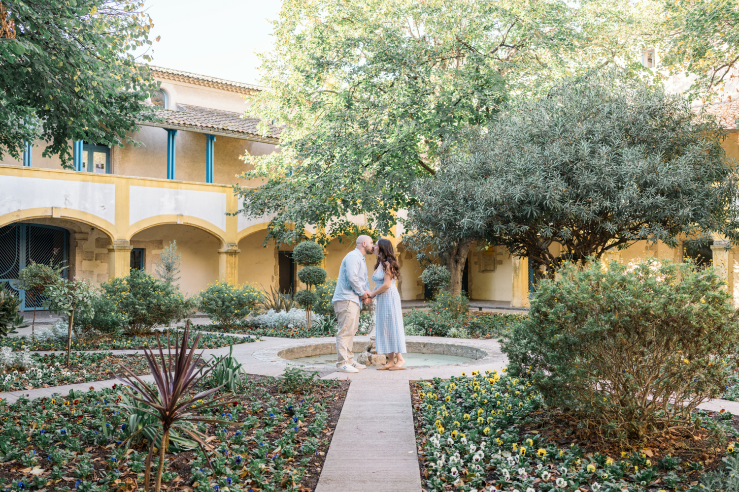 engaged couple kiss in garden in arles france