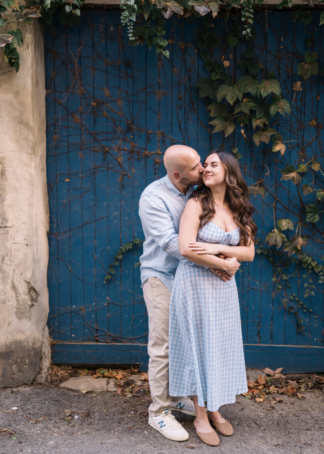 man kisses woman near blue door in arles france