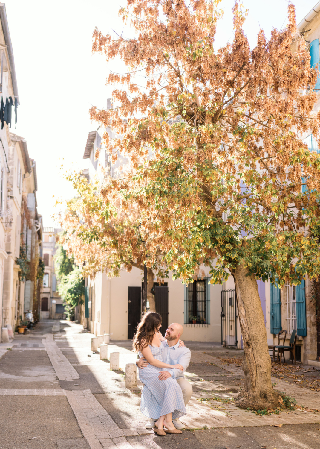 cute couple sit together in charming square in arles france
