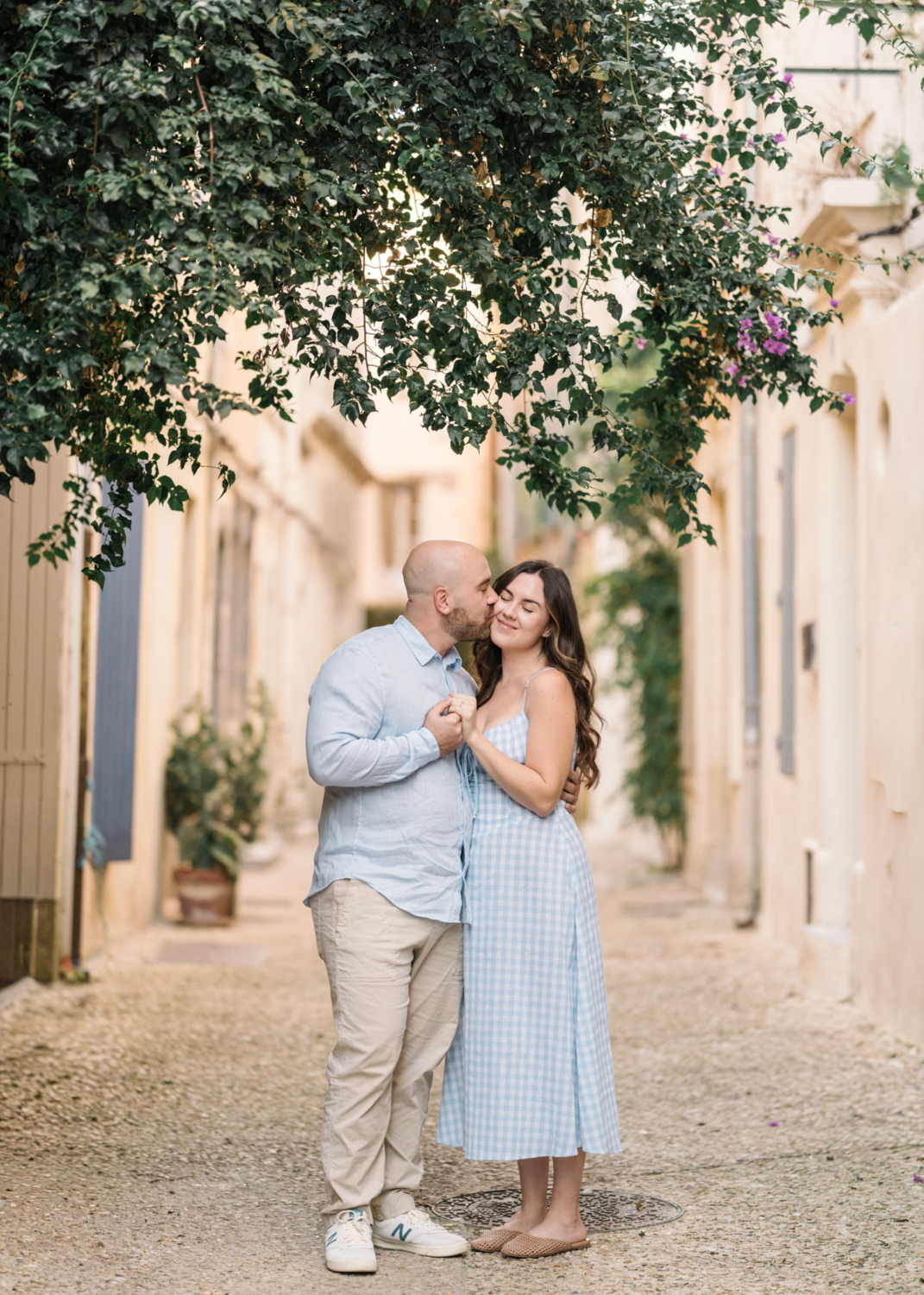 man kisses woman on cheek in arles france