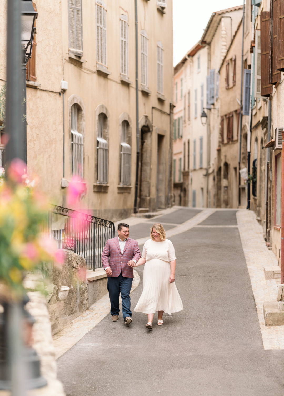 bride and groom walk hand in hand in callas france