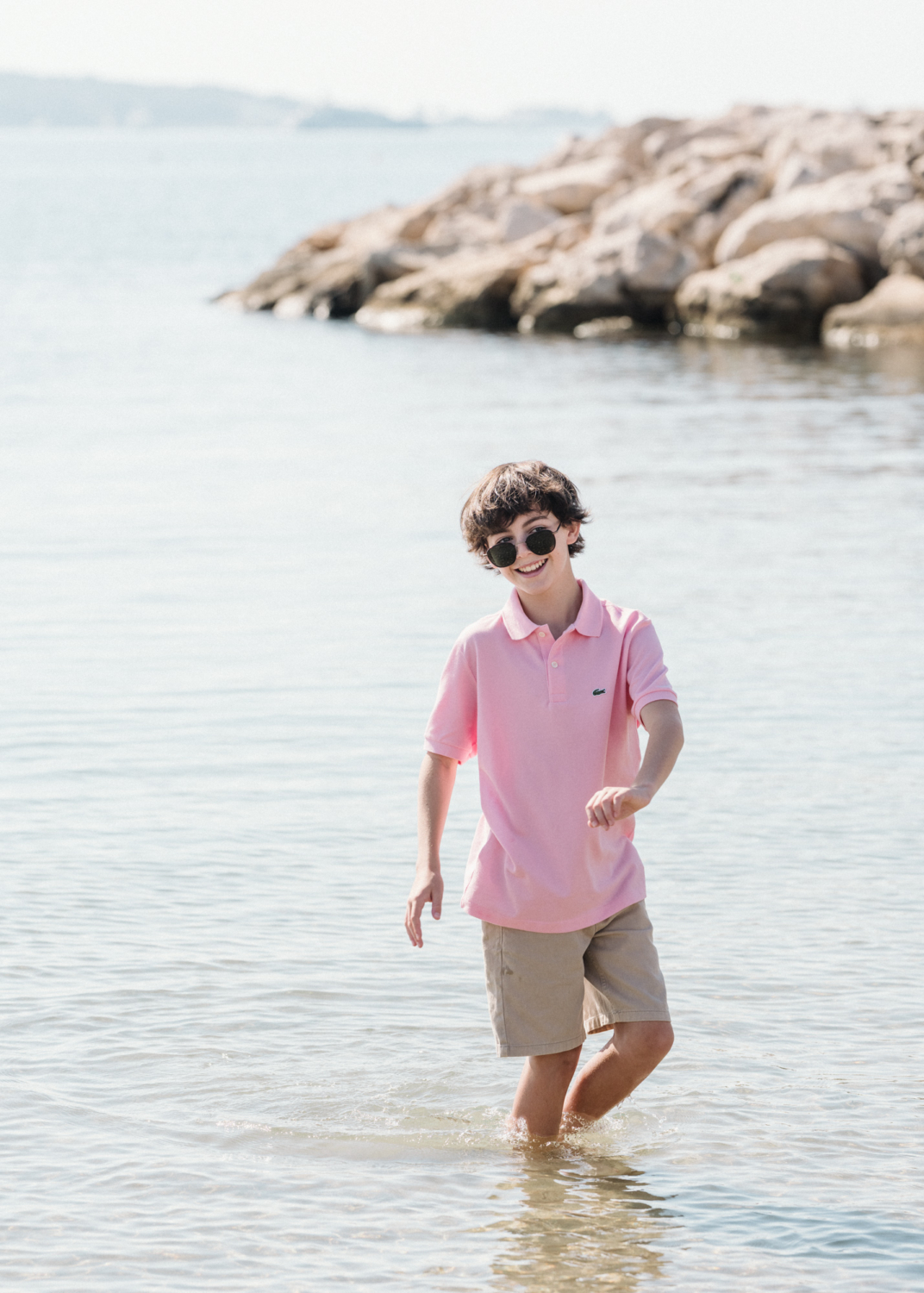 young boy plays in the water in antibes france