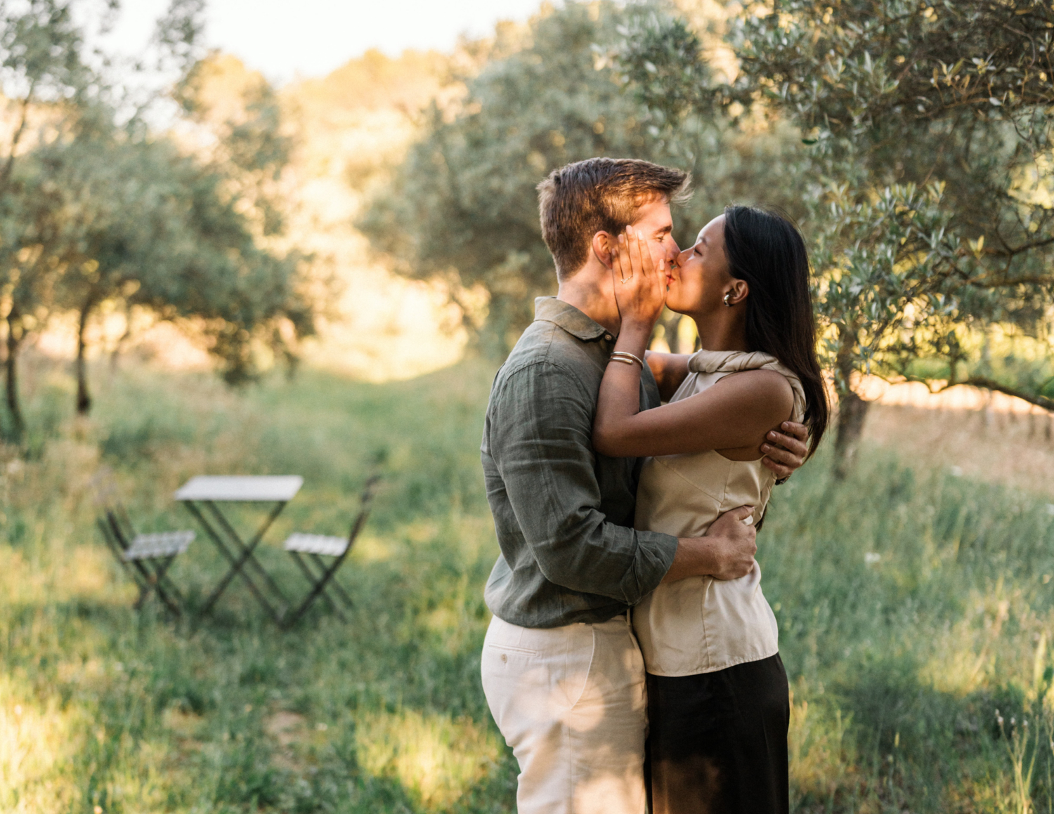 newly engaged couple kiss in vineyard at domaine de fontenille (