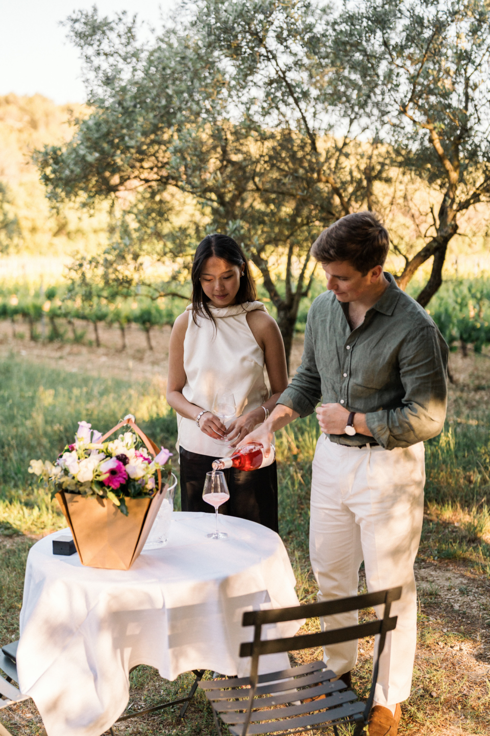 vineyard scene with a newly engaged couple enjoying wine