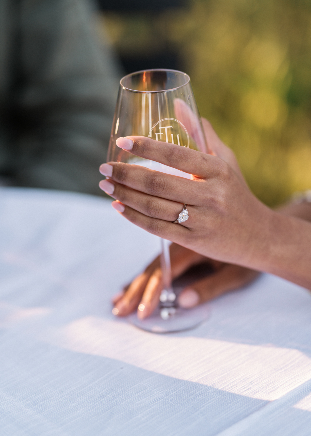 woman wraps her hand around wine glass
