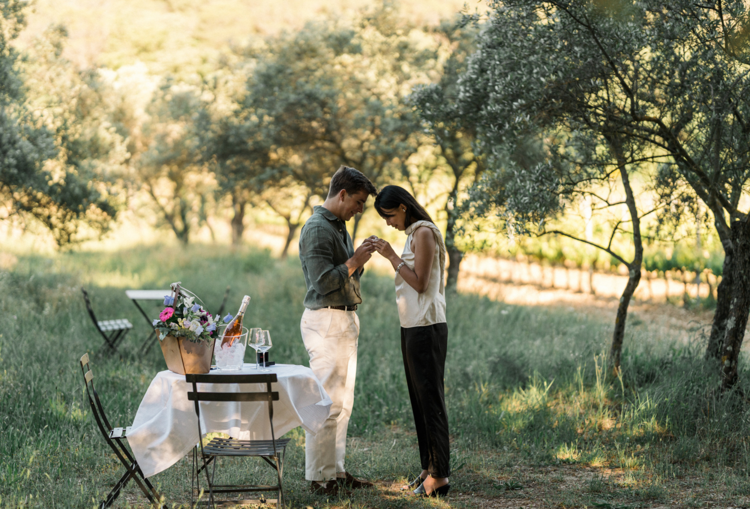 woman looks closely at her engagement ring