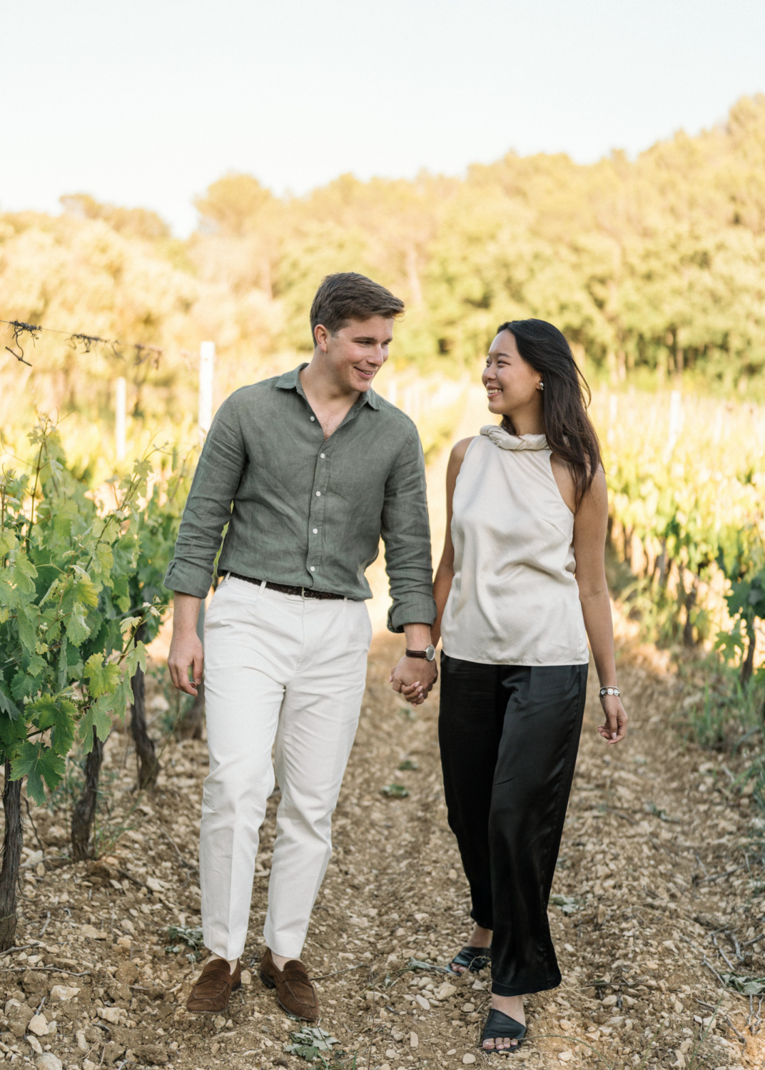 happy couple smiling in vineyard
