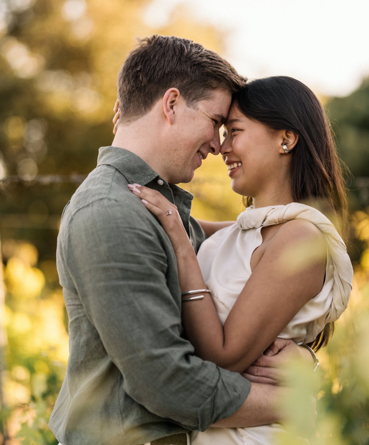newly engaged couple embrace in vineyard in france