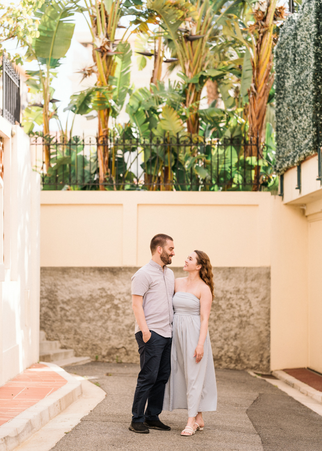 couple pose in monaco near banana trees