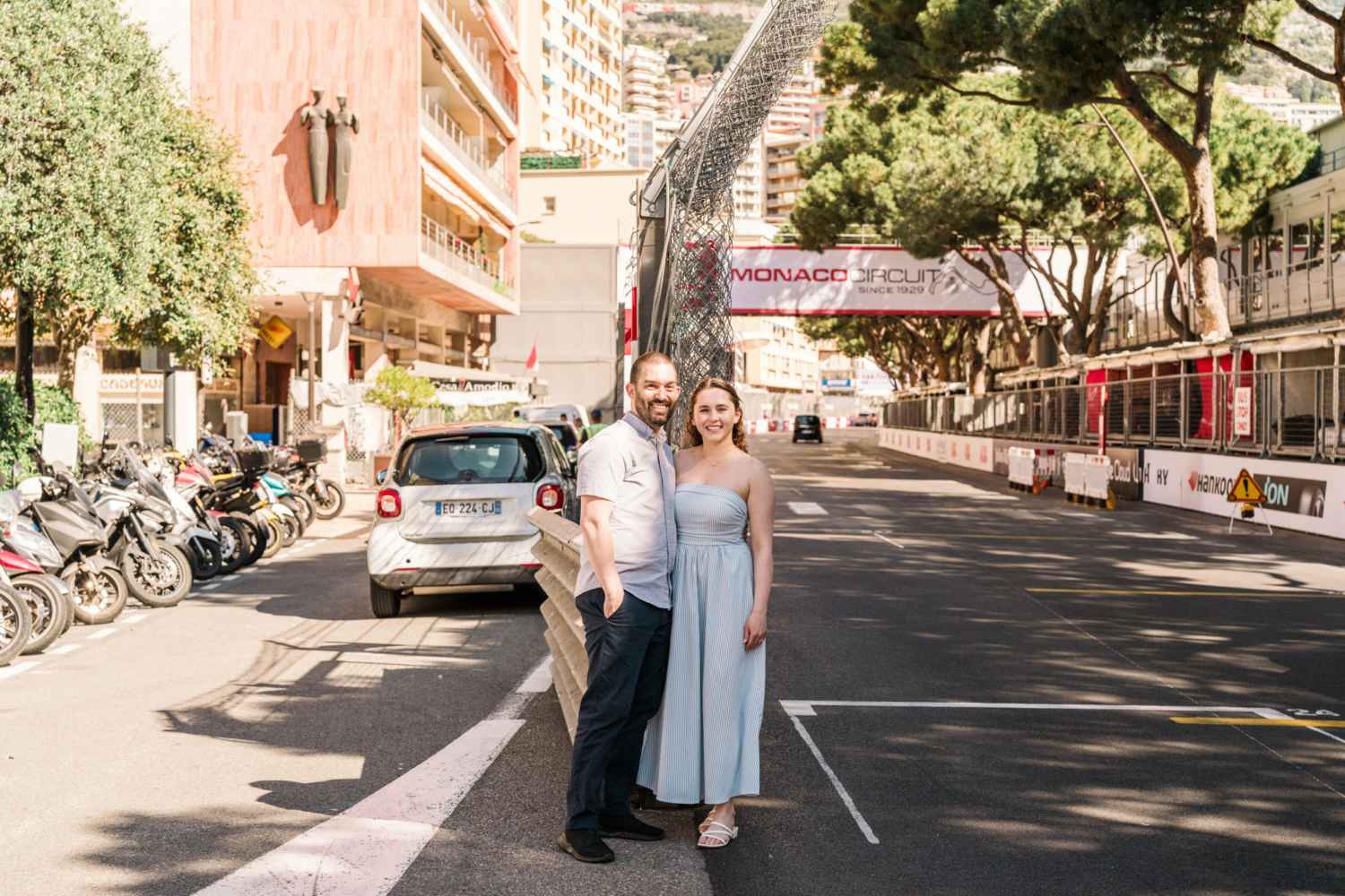 cute couple pose in front of the monaco circuit sign